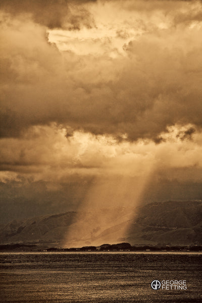 Sunlight penetrates the long white cloud