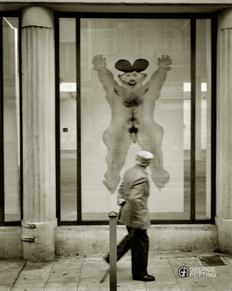 Modern art work hanging with pedestrian getting an eyefull  Nice 