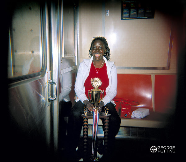 Validictory student heading home with spoils on the train to Coney Island