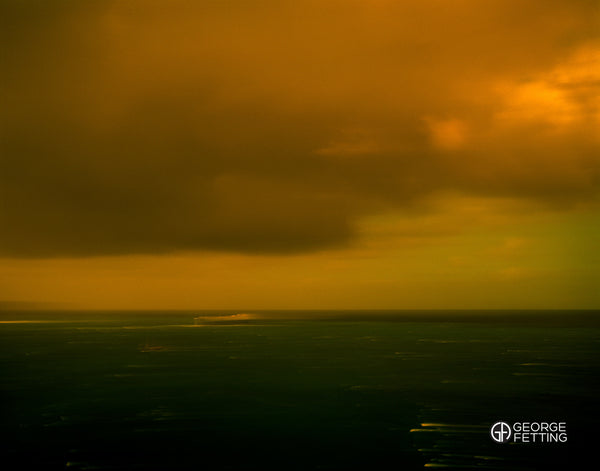 Ethereal afternoon light bathes a passing ship